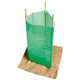 Green Gro-Max Treeguard Sleeve protecting a sapling, secured by three bamboo stakes and a brown weed mat.